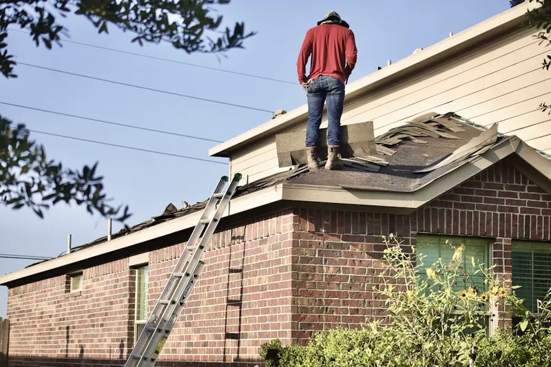 Professional roofer working on a residential roof in McAfee